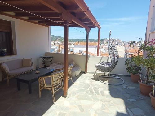 a balcony with a table and chairs and a view at The Fortress, beautiful and private house with top in Skiathos Town