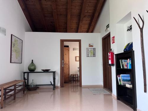 a room with a hallway with a table and a door at Cal Cisteller in Santa Pau