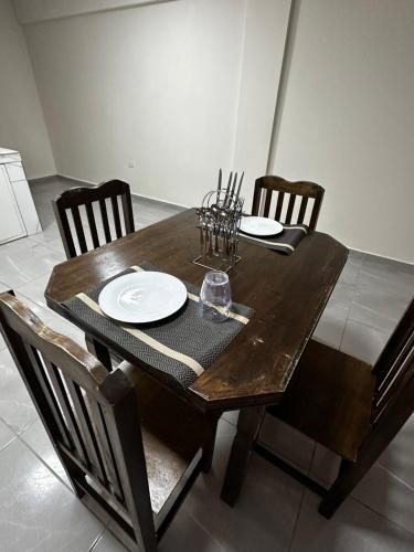 a wooden dining table with chairs and a wooden table and chairsktop at Hollywood Lofts alojamiento in Ciudad del Este
