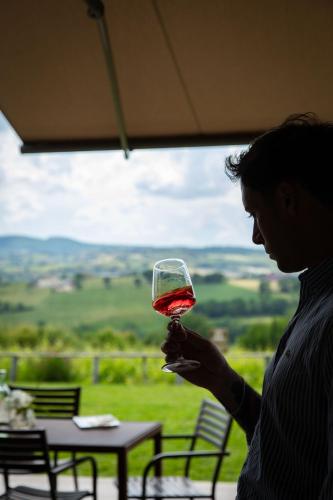 a woman holding up a glass of wine at Retrocantina Antonelli in Montefalco