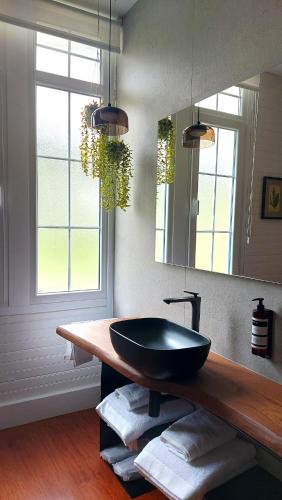 a bathroom with a black bowl sink on a counter at Hotel Quinta Solera in Oviedo