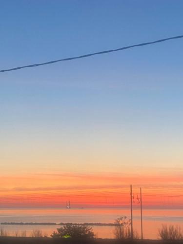 a sunset view of the ocean from a window at Casa del mare in Cupra Marittima