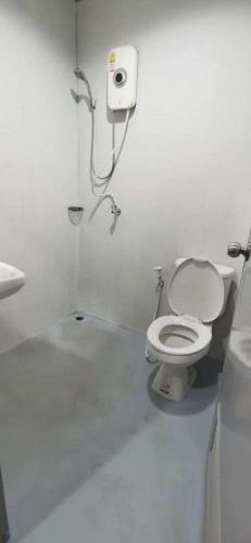 a white bathroom with a toilet and a sink at XX GO INN Bangkok Khaosan Road - โก อินน์ ถนน ข้าวสาร กรุงเทพ Pro in Bangkok