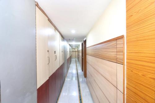 a hallway with wooden walls and a long corridor at HOTEL O Vivek International Hotel in Jalandhar