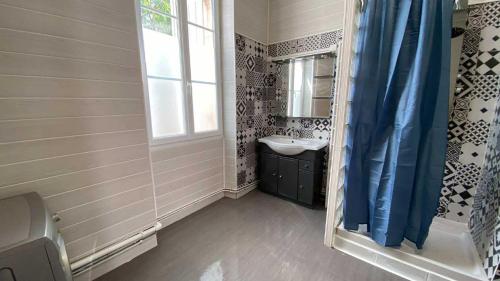 un bagno con lavandino e specchio di Bienvenue chez Lou a Saint-Aubin-de-Blaye
