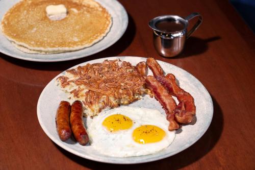 two plates of breakfast food with eggs bacon and pancakes at Luxor in Las Vegas