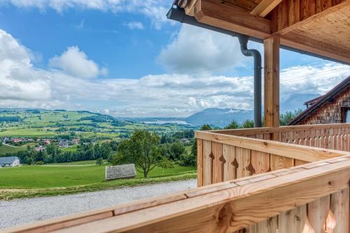 a view from the deck of a cabin with a view of the mountains at ELA Apartments Traunkirchen in Traunkirchen