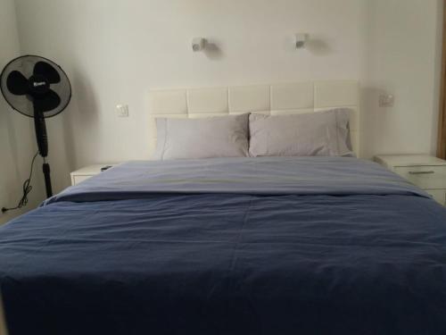 a bedroom with a bed with a blue blanket at Tuneras Sunset Puerto Rico Apartment in Mogán