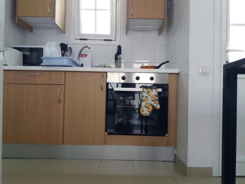 a kitchen with a stove and a sink at Tuneras Sunset Puerto Rico Apartment in Mogán