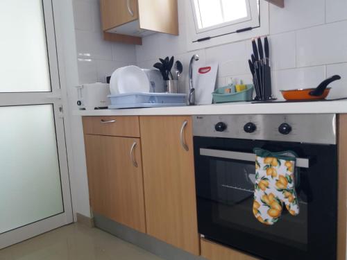 a kitchen with a stove and a counter top at Tuneras Sunset Puerto Rico Apartment in Mogán