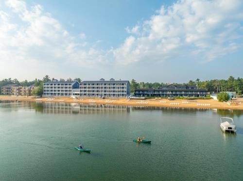 two people in kayaks in a body of water at The Baywatch Resort in Traverse City
