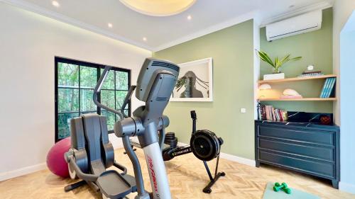 a room with a gym with a treadmill at VILLA SCALINA Seaside Hideaway - 7 Bedroom - Pool - Gym - Walk to beach in Calodyne