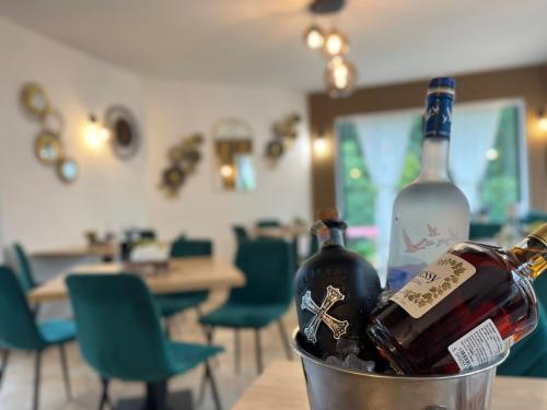 two bottles of wine in a bucket on a table at Pensiunea Georgiana in Durau