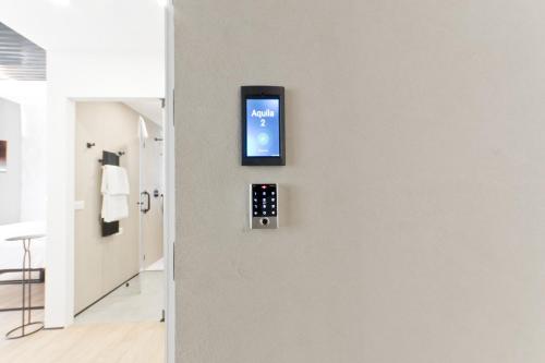 a hotel room with a smart phone on a wall at Borgo Centrale Rooms in Pescara