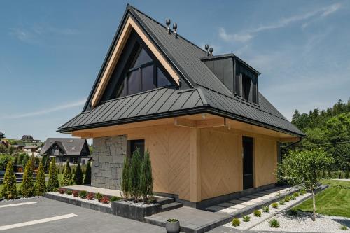a house with a metal roof on top at Osada Maruszyna in Szaflary