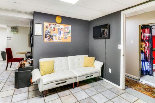 a living room with a white couch against a wall at Hidden Paradise on 5 Acres with Hot Tub and Deck! in Black Jack