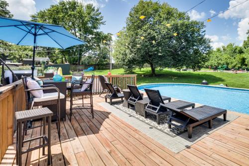 a deck with chairs and tables next to a swimming pool at Hidden Paradise on 5 Acres with Hot Tub and Deck! in Black Jack