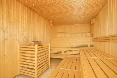 a large wooden sauna with wooden benches in it at Hotel Karolinka in Karpacz