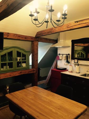a dining room with a table and a mirror at Fotogrāfa Apartamenti in Kuldīga