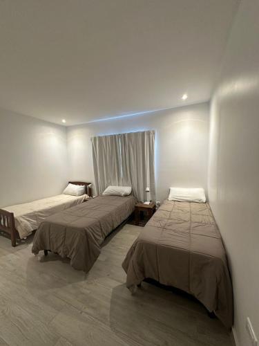 a room with two beds and a window at Ribera de Cafayate in Cafayate