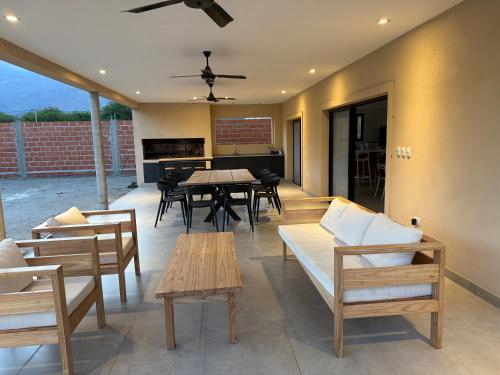 a patio with a table and chairs and a piano at Ribera de Cafayate in Cafayate