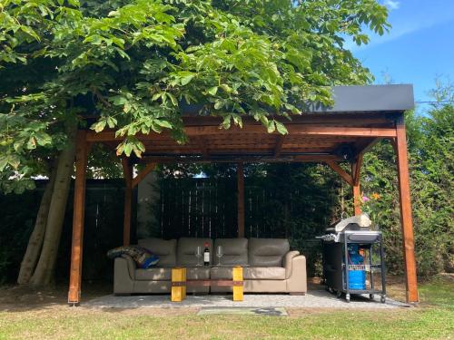 a gazebo with a couch under a tree at +Authentic+ in Mariánské Lázně
