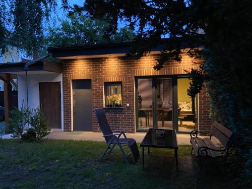 a brick house with two chairs and a table in the yard at +Authentic+ in Mariánské Lázně