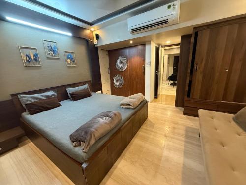 a bedroom with a large bed in a room at Bandra’s Prime luxurious 2 BHK in Mumbai