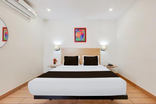 a bedroom with a large bed in a room at Super Townhouse Visakhapatnam in Visakhapatnam