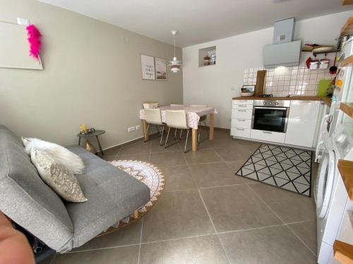 a kitchen and living room with a couch and a table at Hidden Hideaway in Razvala