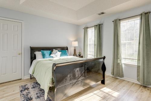 ein Schlafzimmer mit einem Bett mit blauen Kissen in der Unterkunft Spacious Home with Patio 8 Mi to Dtwn Decatur in Decatur
