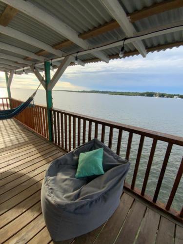 a bean bag chair on a dock next to the water at Peaceful Refuge in Quiete Bay in Bocas del Toro