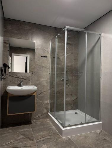 a bathroom with a shower and a sink at Hotel Hostel Перехрестя in Chistilov