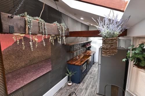 a lobby with a bar and plants on the wall at BurgBnB Downtown in Harrisburg