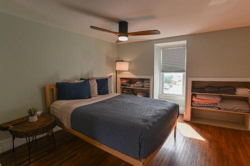 a bedroom with a bed and a ceiling fan at BurgBnB Downtown in Harrisburg