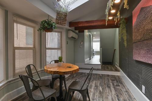 a dining room with a wooden table and chairs at BurgBnB Downtown in Harrisburg