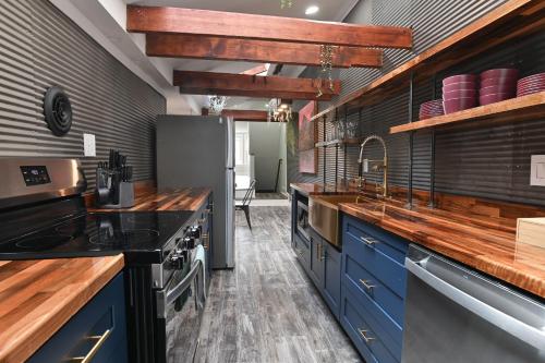 a kitchen with blue cabinets and blue counters at BurgBnB Downtown in Harrisburg