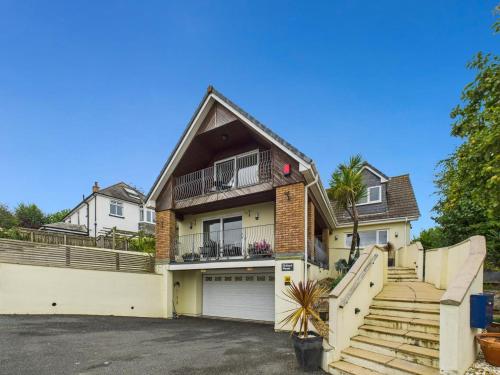 a house with a garage and stairs in front of it at Spacious 3-Bed Home in North Cornwall | Walk to Wadebridge | Near Camel Trail, Padstow & Rock | Free Parking in Wadebridge