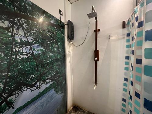 a shower in a bathroom with a wall with a window at Wilpattu Nature Resort in Murandanveli