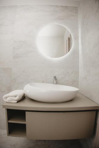 a white bathroom with a sink and a mirror at White House Iris Cluj Napoca - Apartament 3 in Cluj-Napoca