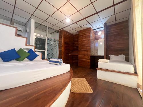 a bedroom with two beds and a mirror at Wilpattu Nature Resort in Murandanveli