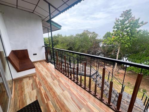 a balcony with a view of a forest at Wilpattu Nature Resort in Murandanveli