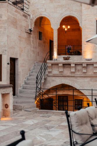a building with a staircase and chairs in a room at Lagoon Cave Suites in Urgup