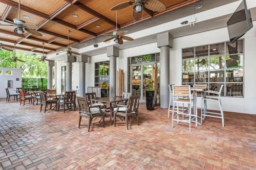 a dining room with tables and chairs and windows at Holiday Inn Tampa Westshore - Airport Area by IHG in Tampa