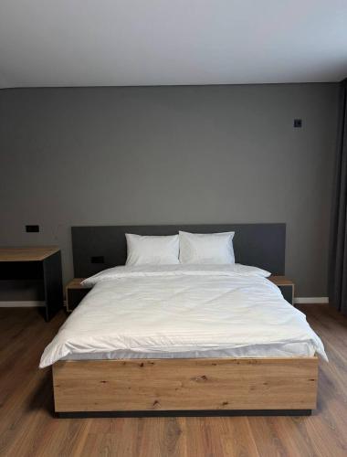 a large bed with white sheets and pillows on it at Hotel Hostel Перехрестя in Chistilov