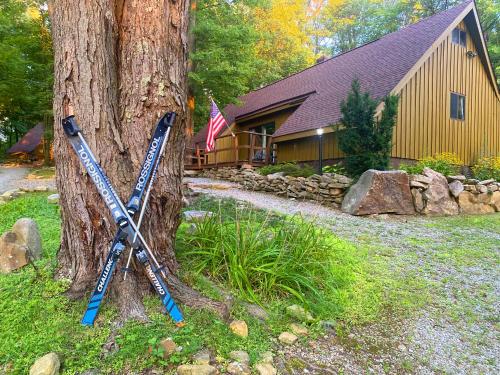 a baseball bat leaning against a tree in front of a house at Claycomb Chalets in Champion