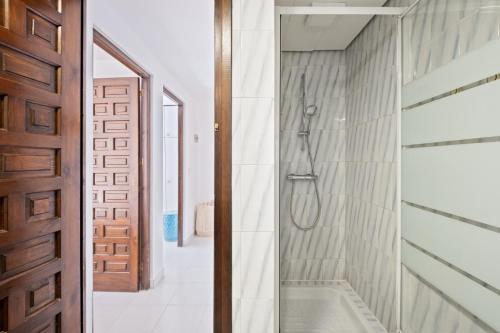 a bathroom with a shower and a glass door at Casa May in La Cala de Mijas