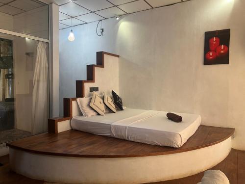 a bedroom with a bed in a room with a staircase at Wilpattu Nature Resort in Murandanveli