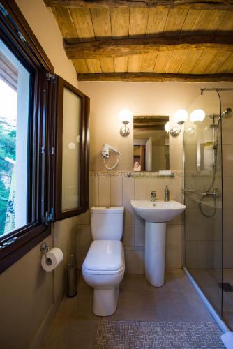 a bathroom with a toilet and a sink at Riverside - Eco Living in Veria