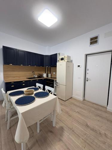 a kitchen with a white table and a white refrigerator at Studio Felix Relax MAO 13&14 in Baile Felix